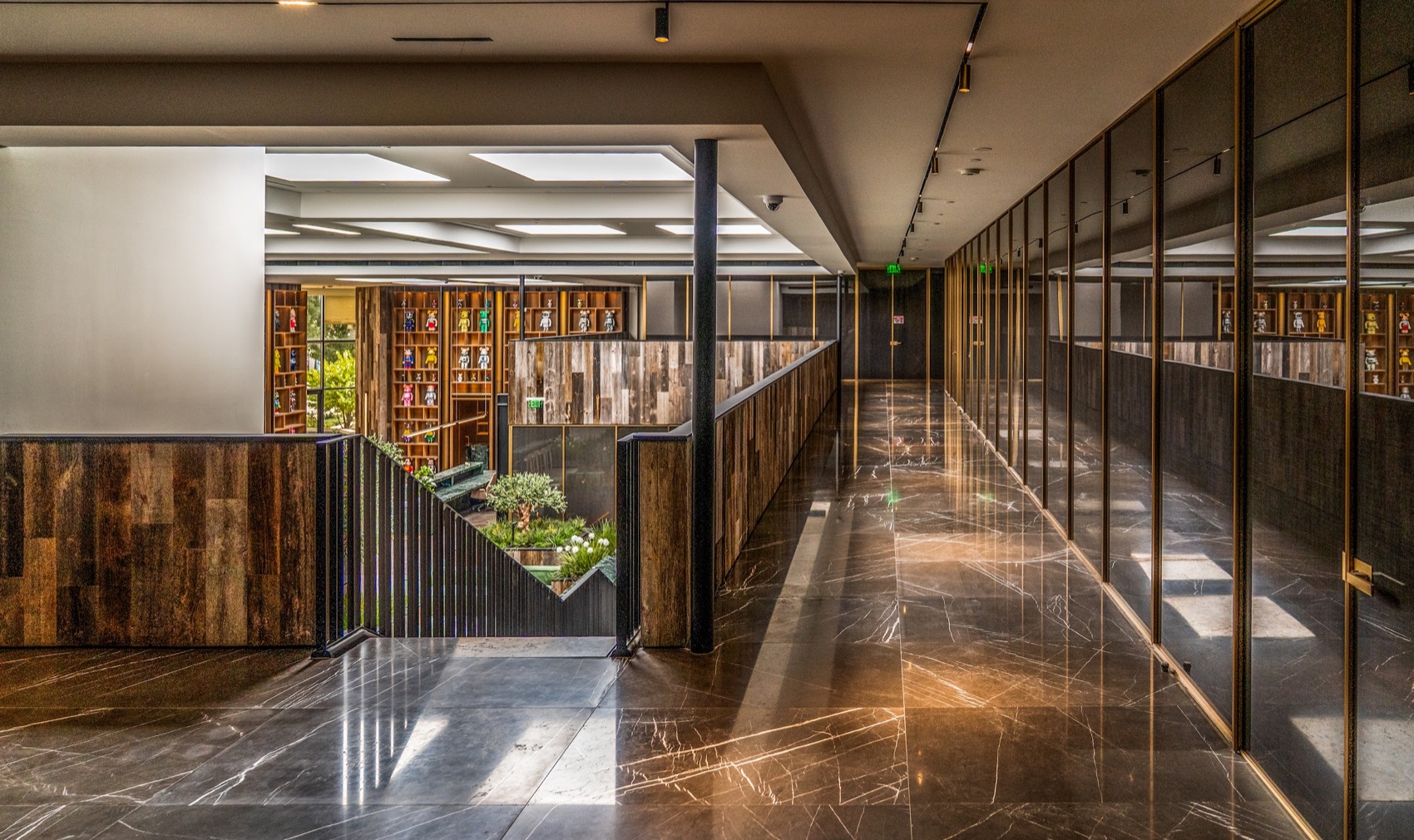 Completed commercial interior with glass, stone, wood, and custom metalwork
